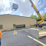 A commercial AC unit being lifted by Missouri Furnace & Air Conditioning.