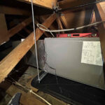 Missouri Furnace & Air Conditioning hanging a furnace.
