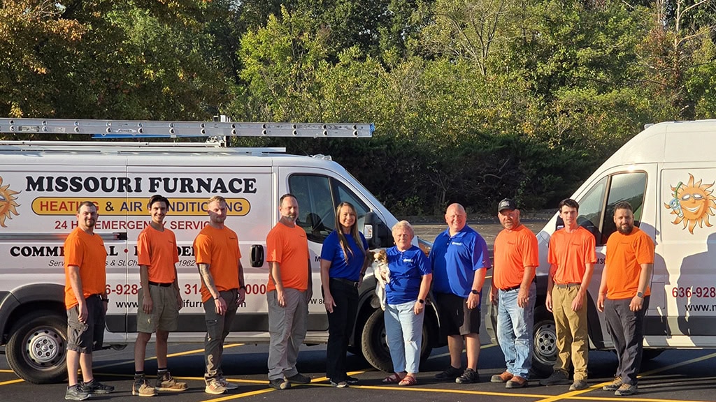Missouri Furnace & Air Conditioning team in front of HVAC service vehicles at Earth City, MO, office.