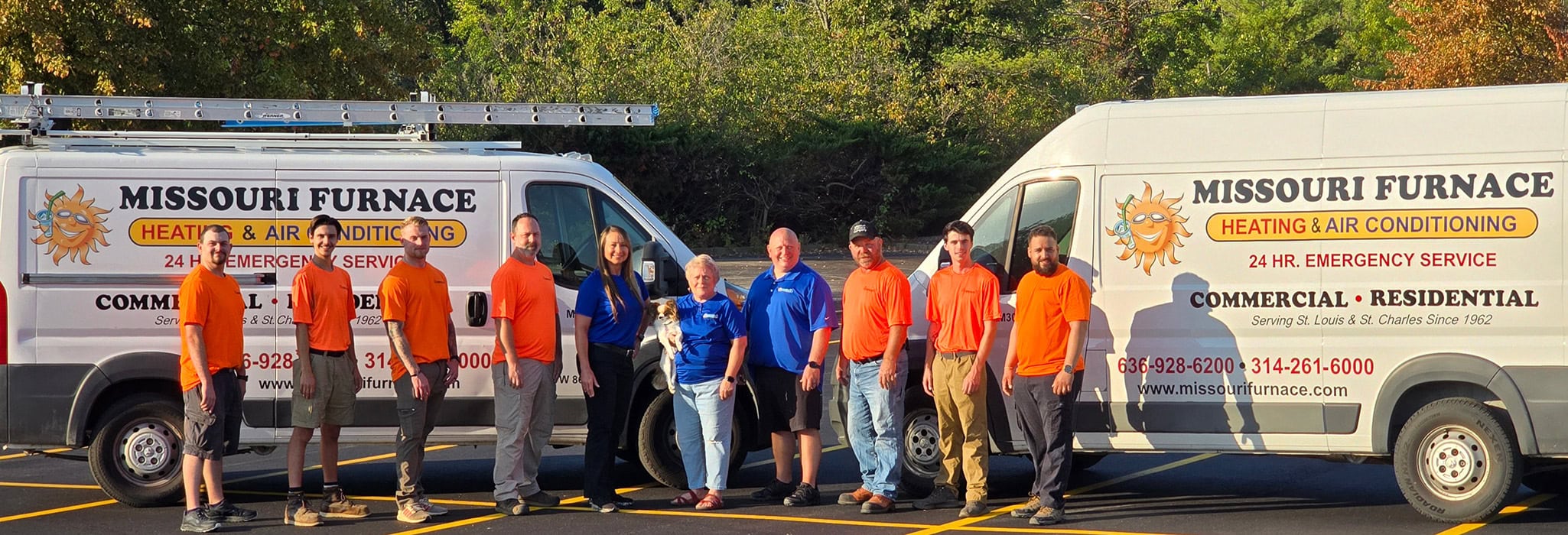 Missouri Furnace & Air Conditioning team in front of HVAC service vehicles at Earth City, MO, office.